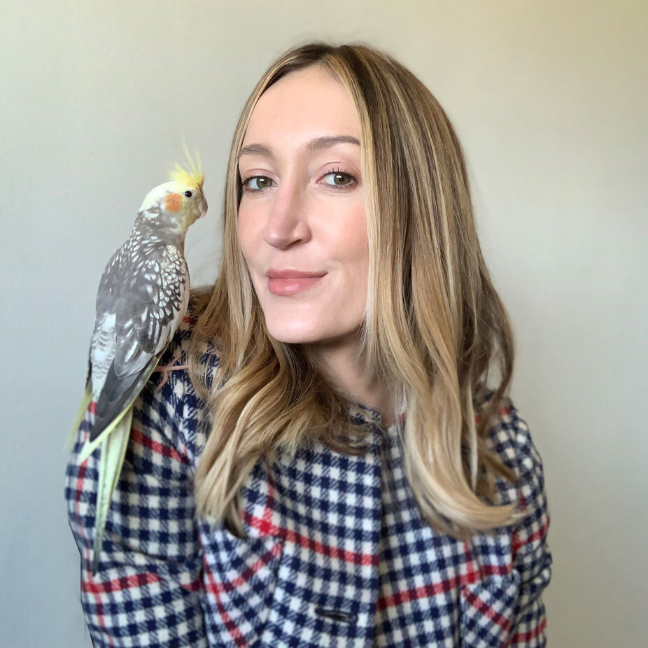 Brenna with her pet cockatiel on her shoulder